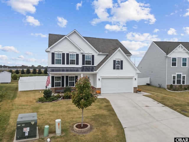 traditional home featuring driveway, a standing seam roof, fence, and a front yard