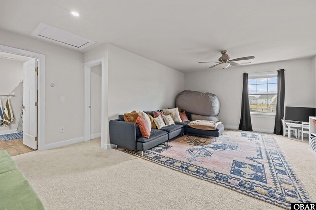 carpeted living room with attic access, recessed lighting, ceiling fan, and baseboards