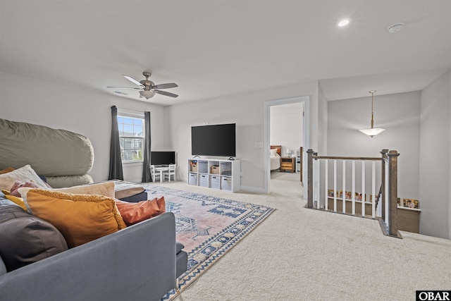 carpeted living area with a ceiling fan, recessed lighting, and baseboards