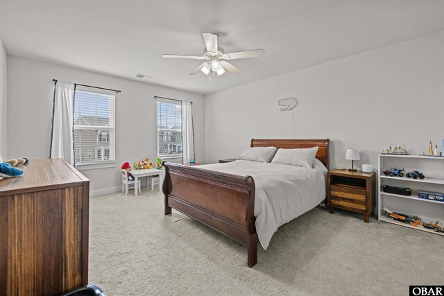 bedroom featuring light carpet, baseboards, visible vents, and a ceiling fan