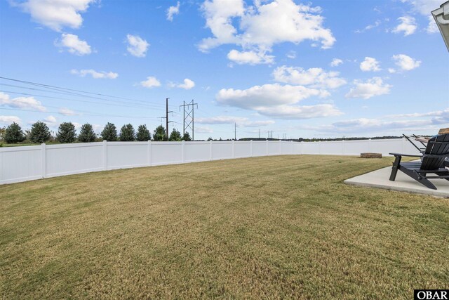 view of yard featuring a water view, fence, and a patio