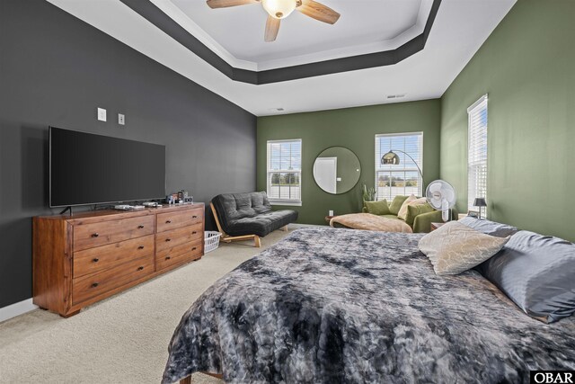 bedroom featuring carpet, a raised ceiling, visible vents, ceiling fan, and baseboards