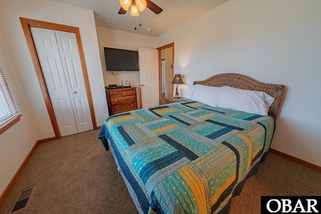 carpeted bedroom featuring baseboards, visible vents, a ceiling fan, and a closet