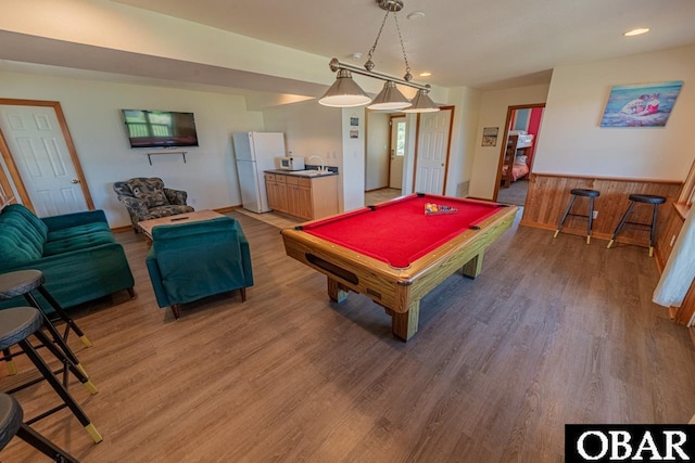 recreation room featuring billiards, wainscoting, light wood-style flooring, and baseboards
