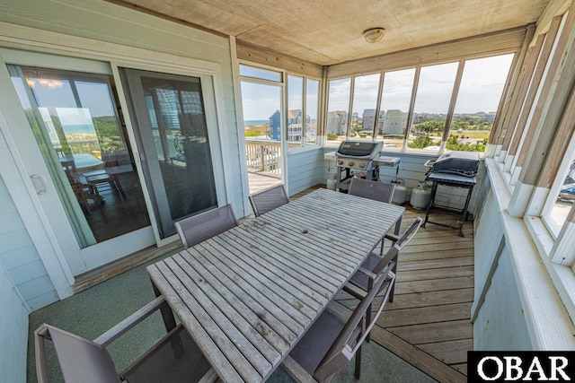 sunroom / solarium featuring a wealth of natural light and a city view