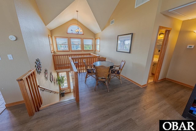 dining area featuring visible vents, wood finished floors, and baseboards