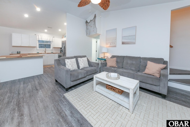 living area featuring high vaulted ceiling, recessed lighting, light wood-style flooring, and a ceiling fan