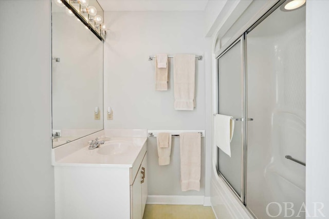 full bath featuring enclosed tub / shower combo and vanity