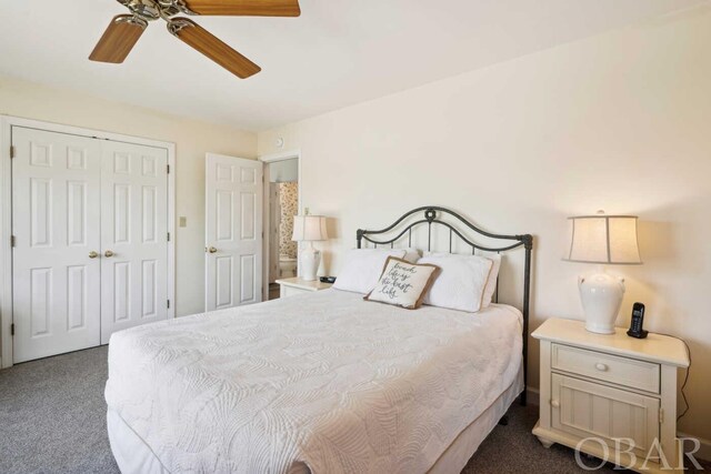 bedroom featuring dark colored carpet, a closet, and a ceiling fan