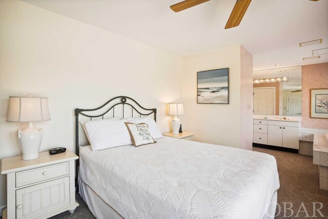 bedroom featuring dark colored carpet, ceiling fan, and ensuite bath