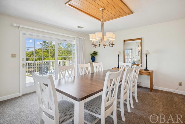 dining space featuring carpet floors, visible vents, baseboards, and an inviting chandelier