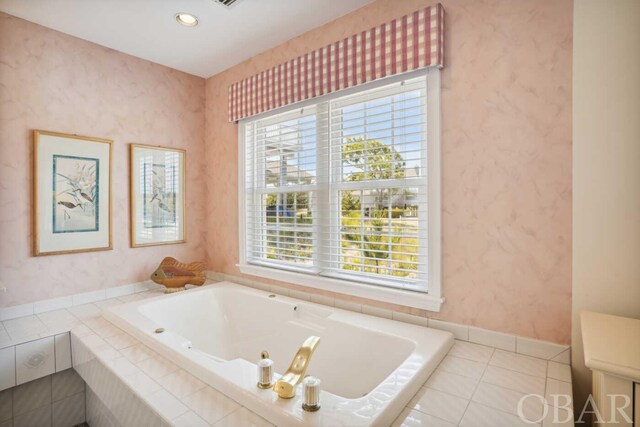 bathroom featuring wallpapered walls, baseboards, a bath, and tile patterned floors