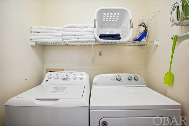 washroom with washing machine and dryer and laundry area