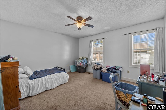 33 Croatan Ct Unit 33, Manteo, NC 27954 - bedroom with a textured ceiling, ceiling fan, baseboards, and carpet