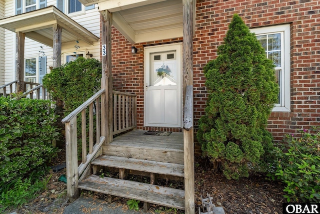 33 Croatan Ct Unit 33, Manteo, NC 27954 - doorway to property with brick siding