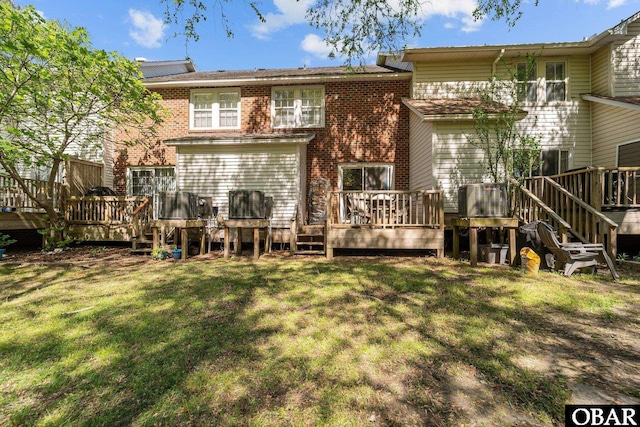 33 Croatan Ct Unit 33, Manteo, NC 27954 - rear view of house featuring brick siding, a deck, and a yard