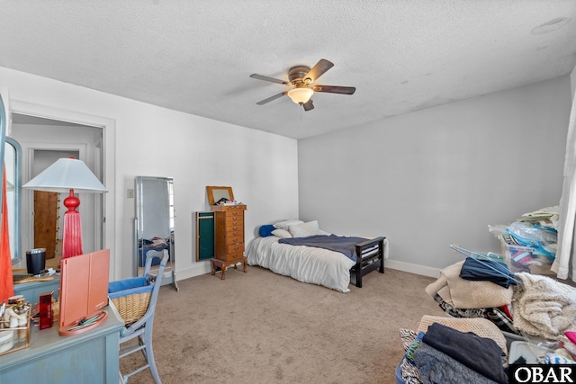 33 Croatan Ct Unit 33, Manteo, NC 27954 - carpeted bedroom featuring baseboards, a textured ceiling, and a ceiling fan