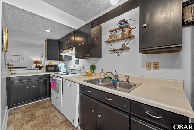 33 Croatan Ct Unit 33, Manteo, NC 27954 - kitchen featuring white appliances, light countertops, a textured ceiling, under cabinet range hood, and a sink