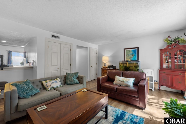 33 Croatan Ct Unit 33, Manteo, NC 27954 - living area with a textured ceiling, wood finished floors, and visible vents