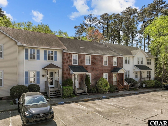 33 Croatan Ct Unit 33, Manteo, NC 27954 - view of property featuring a shingled roof and uncovered parking