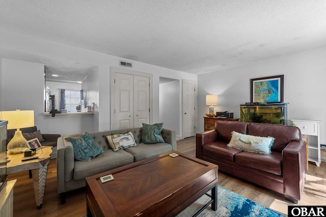 33 Croatan Ct Unit 33, Manteo, NC 27954 - living area with visible vents, a textured ceiling, and wood finished floors