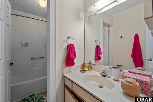 33 Croatan Ct Unit 33, Manteo, NC 27954 - full bathroom featuring vanity, a textured ceiling, and shower / washtub combination