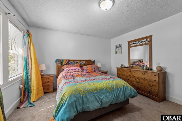 33 Croatan Ct Unit 33, Manteo, NC 27954 - bedroom with baseboards, light carpet, and a textured ceiling