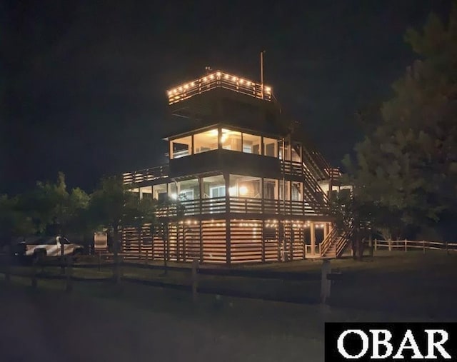 property at night featuring stairs