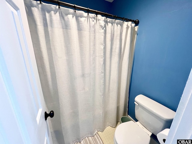 full bath featuring toilet and curtained shower