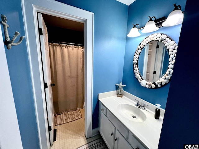 bathroom featuring a shower with shower curtain, tile patterned flooring, and vanity