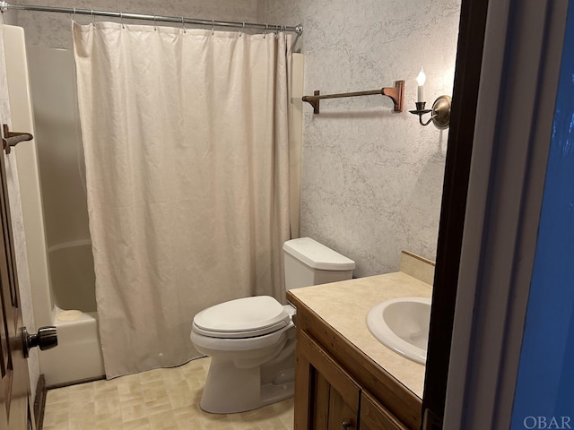 full bath featuring toilet, shower / tub combo, vanity, and a textured wall