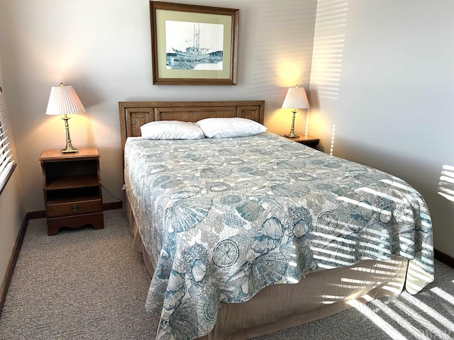 bedroom with light colored carpet and baseboards