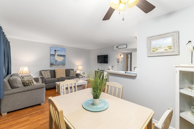 dining space featuring ceiling fan and wood finished floors