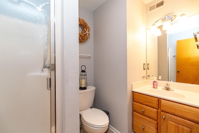 full bathroom featuring toilet, vanity, and visible vents