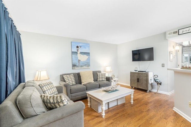 living room featuring baseboards and wood finished floors