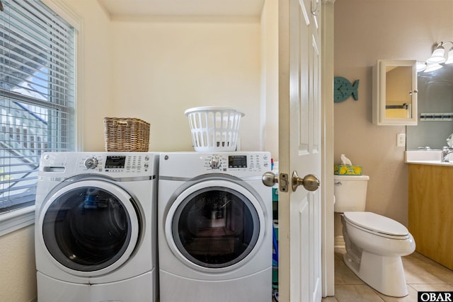 1800 Saint David Rd Unit 104-D 2, Kill Devil Hills, NC 27948 - washroom featuring separate washer and dryer, healthy amount of natural light, and light tile patterned flooring
