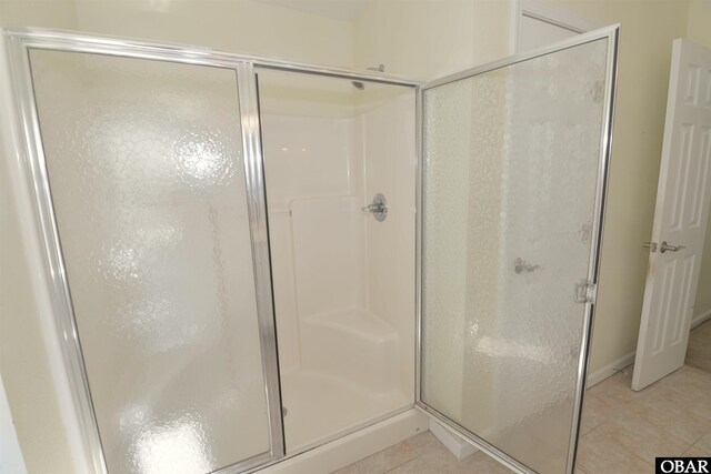 bathroom featuring a stall shower and tile patterned flooring