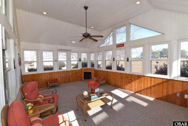 sunroom with vaulted ceiling and a wall mounted AC