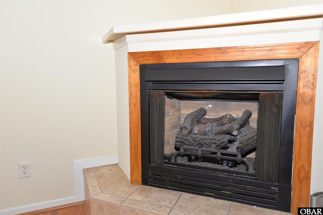 details featuring a fireplace and baseboards