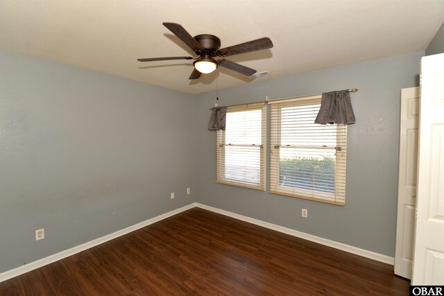 unfurnished room featuring visible vents, ceiling fan, baseboards, and wood finished floors