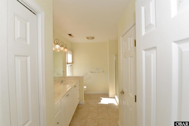 full bath with double vanity, visible vents, toilet, tile patterned flooring, and a sink