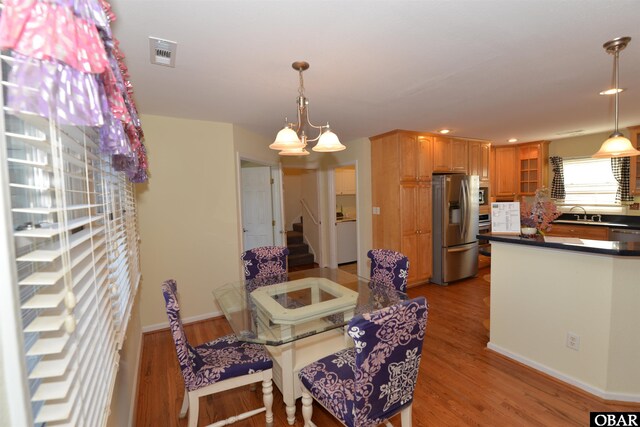 dining area featuring a notable chandelier, visible vents, wood finished floors, and recessed lighting