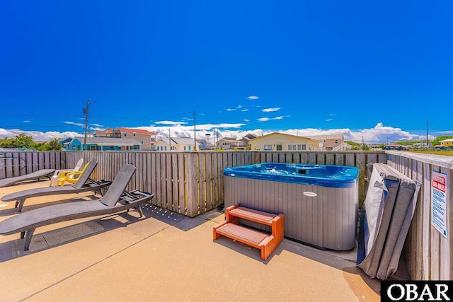 view of patio featuring a residential view and a hot tub