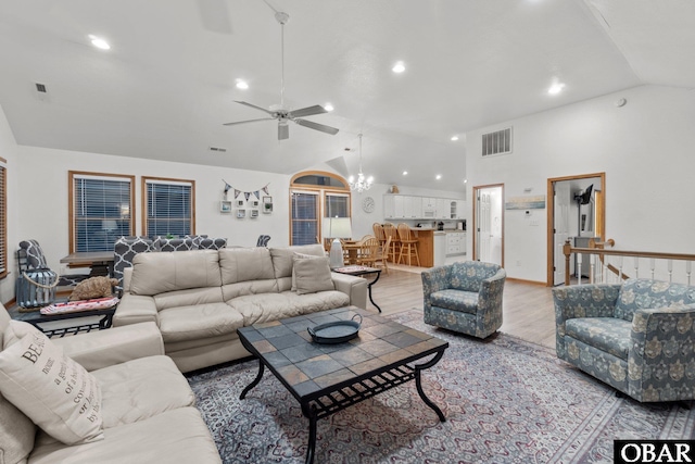 living room featuring high vaulted ceiling, visible vents, and light wood-style floors