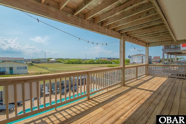 wooden deck featuring a lawn