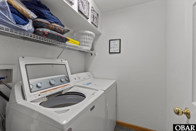 laundry area featuring laundry area, washer and clothes dryer, and baseboards