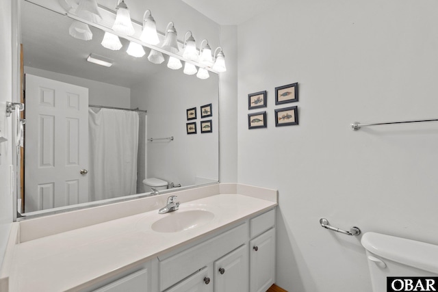 bathroom featuring toilet and vanity