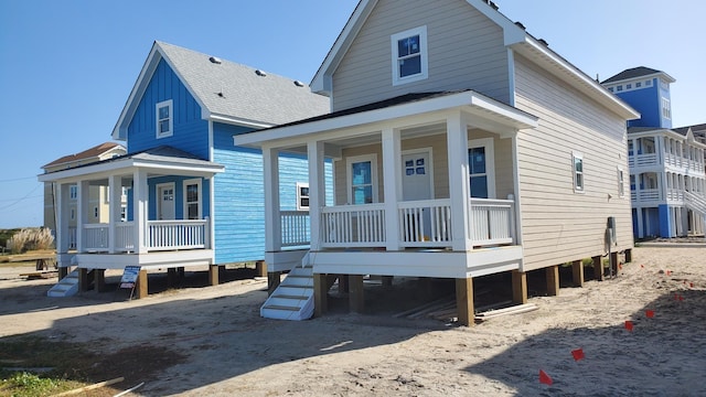 view of front facade featuring a porch and a shingled roof