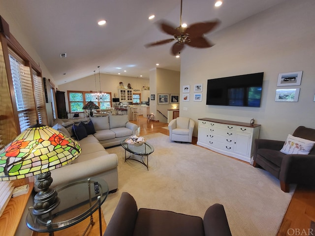 living room featuring a ceiling fan, lofted ceiling, visible vents, and recessed lighting