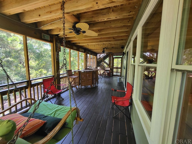 sunroom featuring wooden ceiling, a healthy amount of sunlight, and ceiling fan